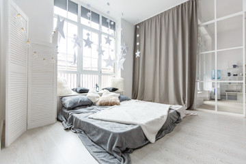 Fototapeta na wymiar Gray bedroom with big window, double bed in scandinavian style