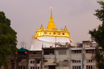 View of the chedi of the Temple of the Golden Mountain (Wat Saket) in the evening twilight. Bangkok, Thailand