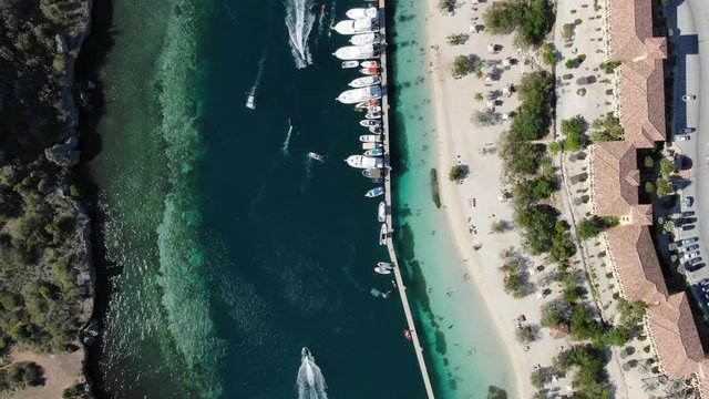 Aerial top-down shot of Tropical Bay with Yachts near Beach