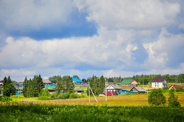 Fototapeta na wymiar Russia. View of the village. Summer rural landscape with houses