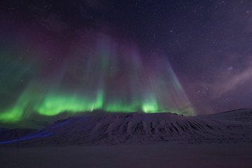 The polar arctic Northern lights aurora borealis sky star in Norway travel Svalbard in Longyearbyen city the moon mountains