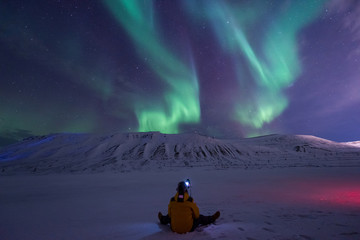 The polar arctic Northern lights aurora borealis sky star in Norway travel Svalbard in Longyearbyen city the moon mountains