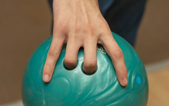 Green Bowling Ball In The Player's Hand