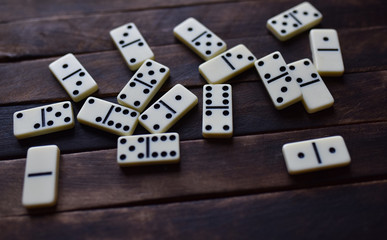 white dominoes on a wooden table