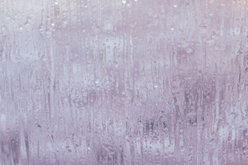 Frozen window in winter with drops and drips