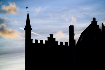 silhouette of building in brugge at sunset