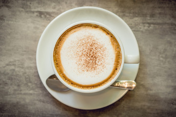 Hot coffee and hot tea place on the marble table in early morning with copyspace, white cup and silver spoon.