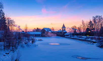 Fototapeta premium Winter sunrise over a snow-covered lake