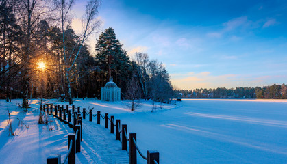 Fototapeta premium Winter sunrise over a snow-covered lake