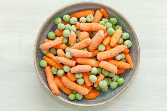 Bowl Of Frozen Green Peas And Carrot.