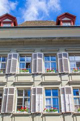 Old houses in Bern. Houses with flowers on the windows. Architecture of Bern