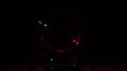 Closeup shot of red flashing light inside a crystal ball