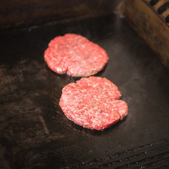 Burger on a stove background. Cooking delicious hamburger cheeseburger with bacon. Healthy fresh food hot heat for eating 