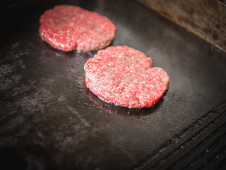 Burger on a stove background. Cooking delicious hamburger cheeseburger with bacon. Healthy fresh food hot heat for eating 