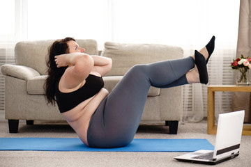fitness, sport, weight loss, exercising, home workout, training, lifestyle. young plus size woman...