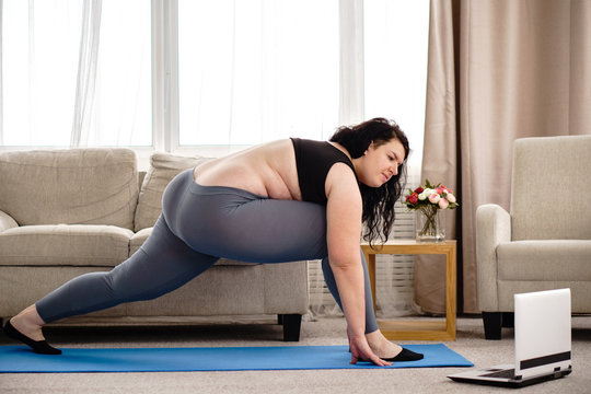 Fitness, Online Personal Trainer, Technology And Diet. Yoga Workout For Women. Overweight Woman Stretching During Home Training