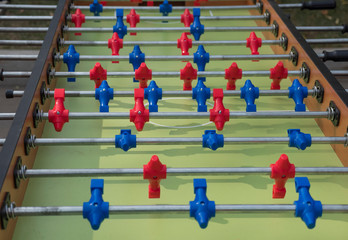 Table football in the entertainment center. Close-up image of plastic players in a football game