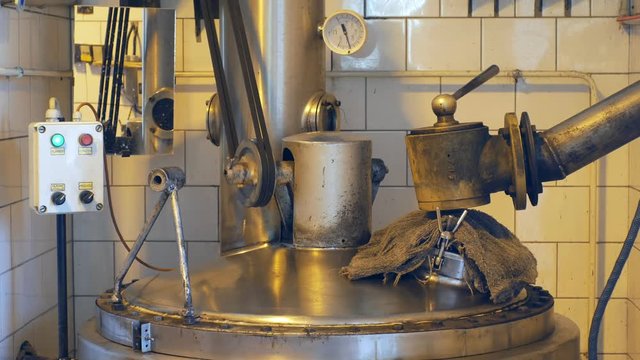 OLOMOUC, CZECH REPUBLIC, SEPTEMBER 30, 2018: Growing distillery for the production of plum brandy by firing in a gas boiler, bottles plum liquor slivovitz, simple manufacturing system burning