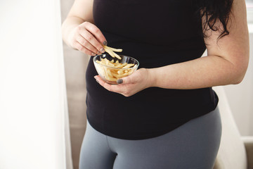 weight loss, overweight, plus size, diet, unhealthy eating, fast food, overeating. fat woman with...