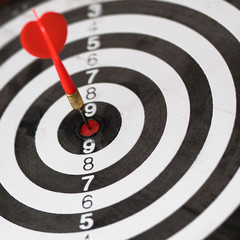 Dartboard with dart in center. Concept of target  in business and success