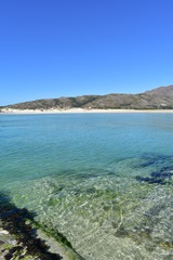 Fototapeta na wymiar Beach with mountain, lake, white sand and clear water with turquoise colour. Playa de Carnota, Coruña Province, Spain.