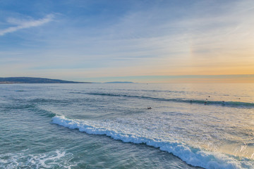 Surfers in the Pacific Ocean at Sunset