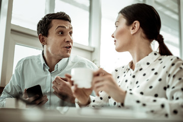 Joyful young man speaking with his partner