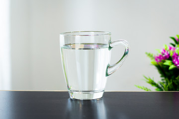 Glass of water on the table background