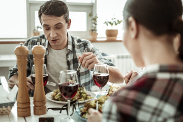 Attentive brunette man eating fresh healthy food