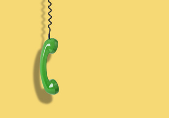 Telephone receiver hanging from the cord