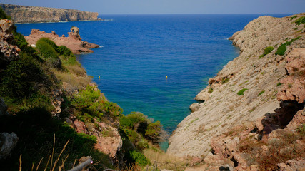 Obraz premium Beautifull view of Cala Morell cove, red rocks and clear blue water, Menorca island, Balearic Islands, Spain.