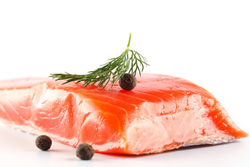 salmon on a white background with herbs and spices