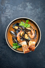 Traditional French Corsican seafood stew with prawns and mussels as top view in a modern design bowl with copy space