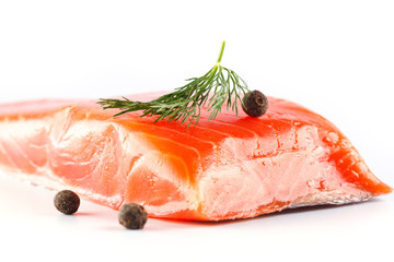 salmon on a white background with herbs and spices