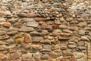 Medieval Stone Wall Texture. Old brick and stone wall with thick grout and very rough, irregular surface.