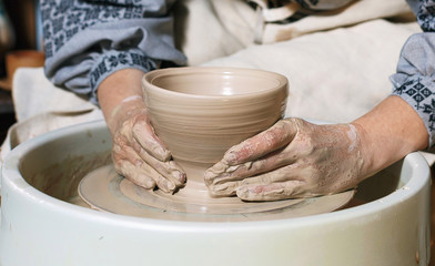 potter working on a form of clay for the manufacture of products with special equipment
