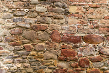 Medieval Stone Wall Texture. Old brick and stone wall with thick grout and very rough, irregular surface.