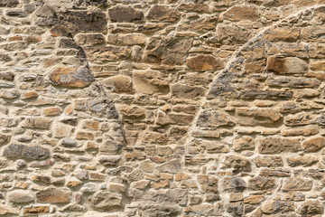 Medieval Stone Wall Texture. Old brick and stone wall with thick grout and very rough, irregular surface.