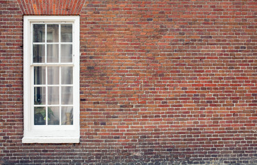 Brick wall with only one window house front / facade with lots of copy space