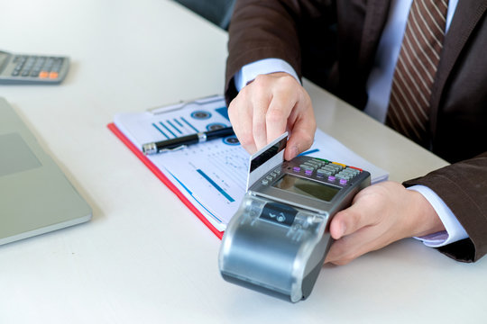 Close up. Payment using credit card swiping machine to pay