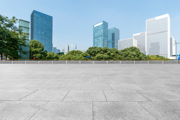 Fototapeta na wymiar Empty Plaza floor tiles and the skyline of modern urban buildings in Hangzhou..