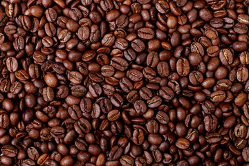 Aroma roasted coffee beans, brown banner background. Soft focus close up.