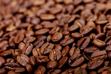 Aroma roasted coffee beans, brown background. Soft focus close up.