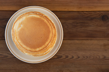 Pancakes. Stack of isolated american pancakes over wooden table. breakfast, food.