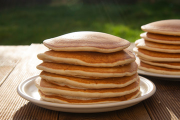 Pancakes. Stack of isolated american pancakes over wooden table. breakfast, food.