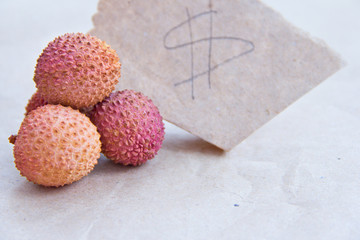 How much is lychee fruit? Lychee fruit close-up on wrapping paper.