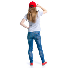 Woman in jeans red cap sneakers standing on white background isolation, back view
