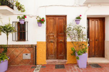 Fototapeta na wymiar Pelargoniums in Purple Clay Flowerpots at Doors in Estepona Andalusia Spain