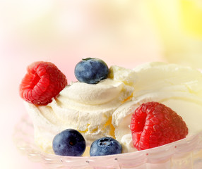 Vanilla ice cream with fresh raspberries and blueberries