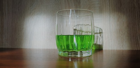 Drink green. Green carbonated lemonade. Green drink in a glass beaker.